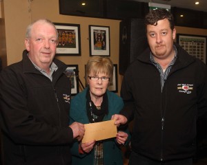 Mary Service receives a cheque for the Carrick Day Centre receives a cheque for E360 from Brendan Byrne and Daniel Moy on the Midwest Donegal Vintage Club, part proceeds of their Kilcar Tractor run. (John/jmac.ie)
